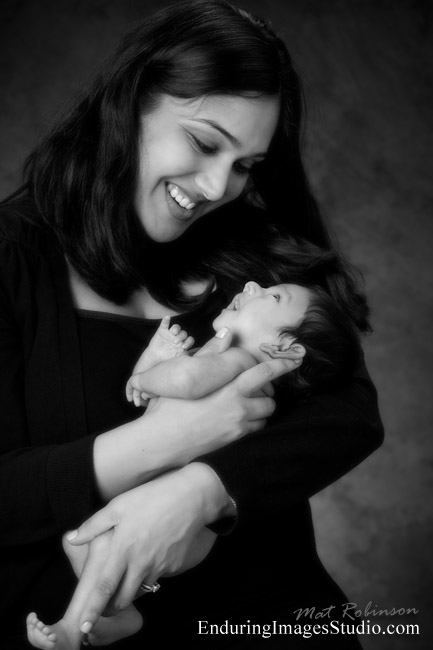 Portrait of mother holding her newborn, black and white classic newborn photograph